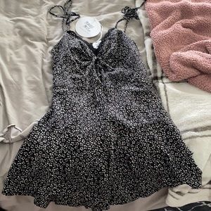 Size 4. Black romper with lace and white flowers.